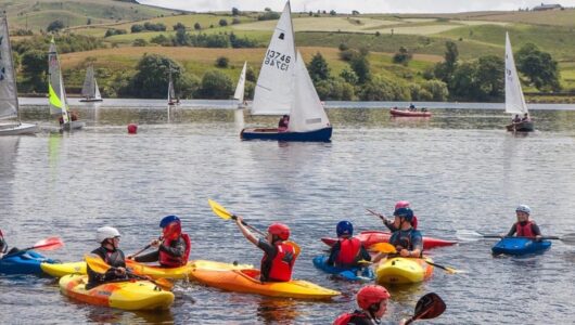 A group of people kayaking on a lake