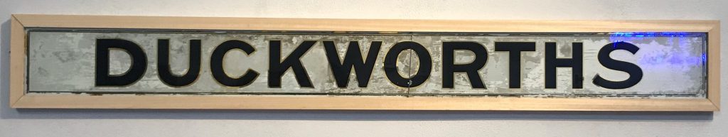 What's Changed? 9. Large hand-painted glass sign for Duckworth’s grocers, 1869
