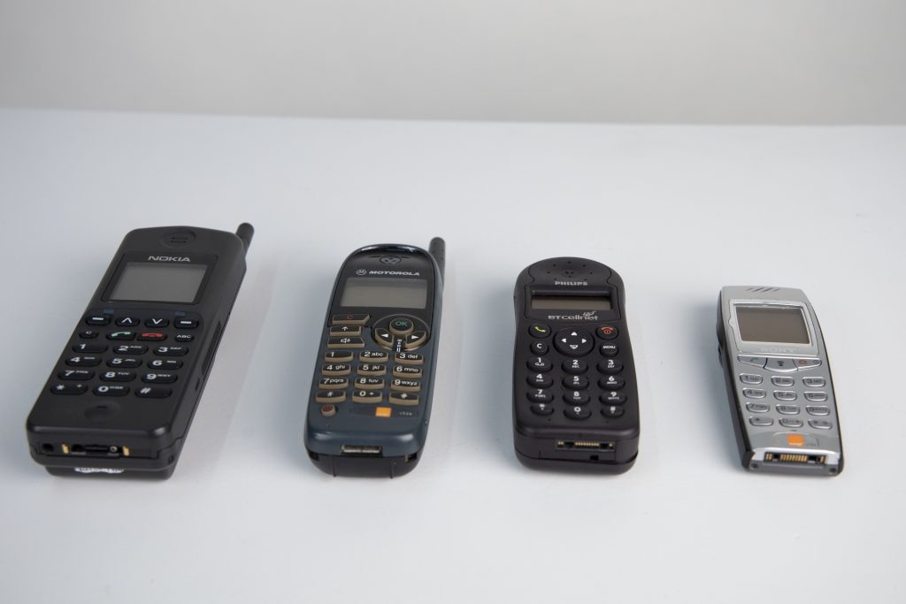 What's Changed? 27. Selection of mobile phones and black Bakelite telephone, 1940-2001