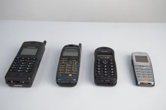 What's Changed? 27. Selection of mobile phones and black Bakelite telephone, 1940-2001