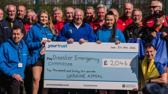 Greater Manchester Walking Football League presenting a large cheque for £2046 raised for Ukraine